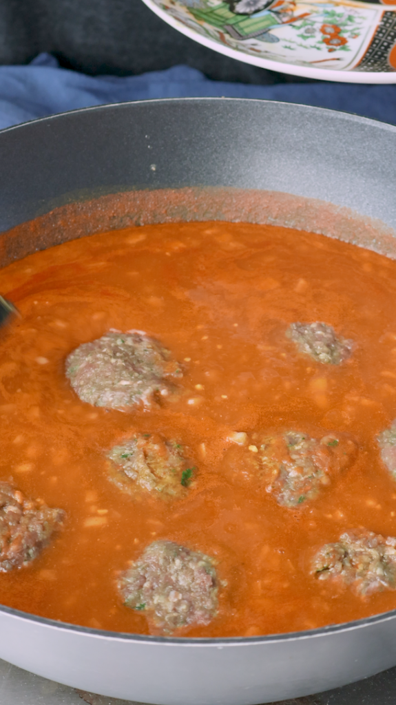 Stir everything together and add water to create the curry sauce. Allow the curry to simmer, and then add the meatballs (kofta) to the sauce. 